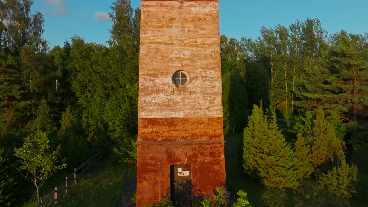 Soviet style lighthouse in rural nature at golden hour