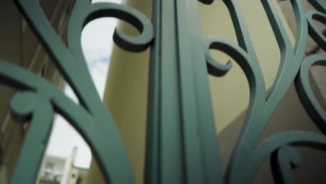 green ornate iron gate with traveling camera in downtown 4k