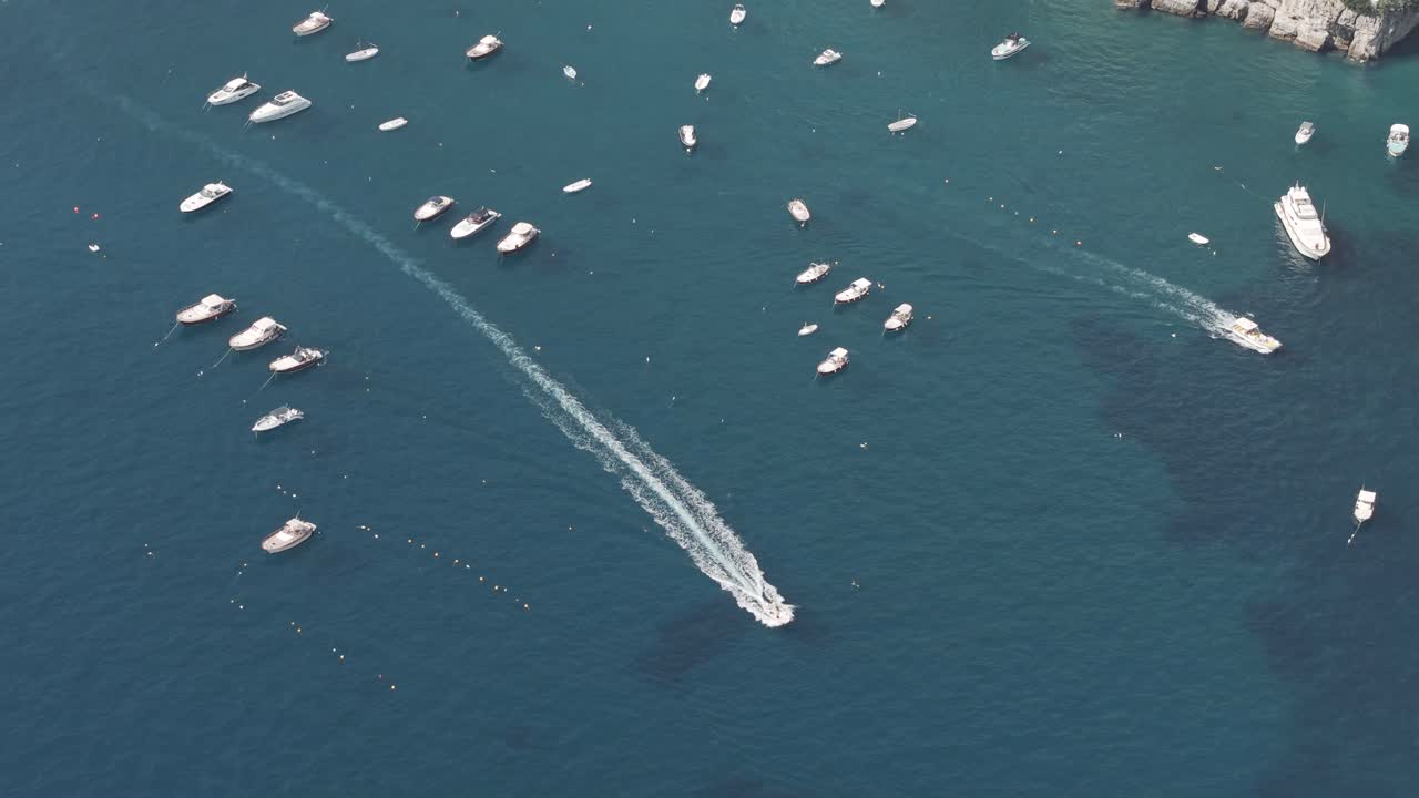 Close-Up Aerial Shot Focusing on a Speedboat Zipping Across the Deep Blue Sea