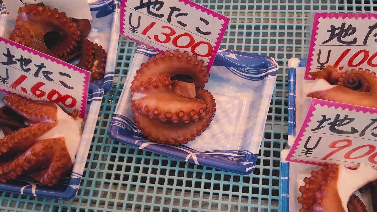 Closeup seafood octopus sliced for sale, Japanese fish market yen currency price