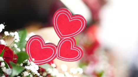 red wooden hearts on a floral arrangement