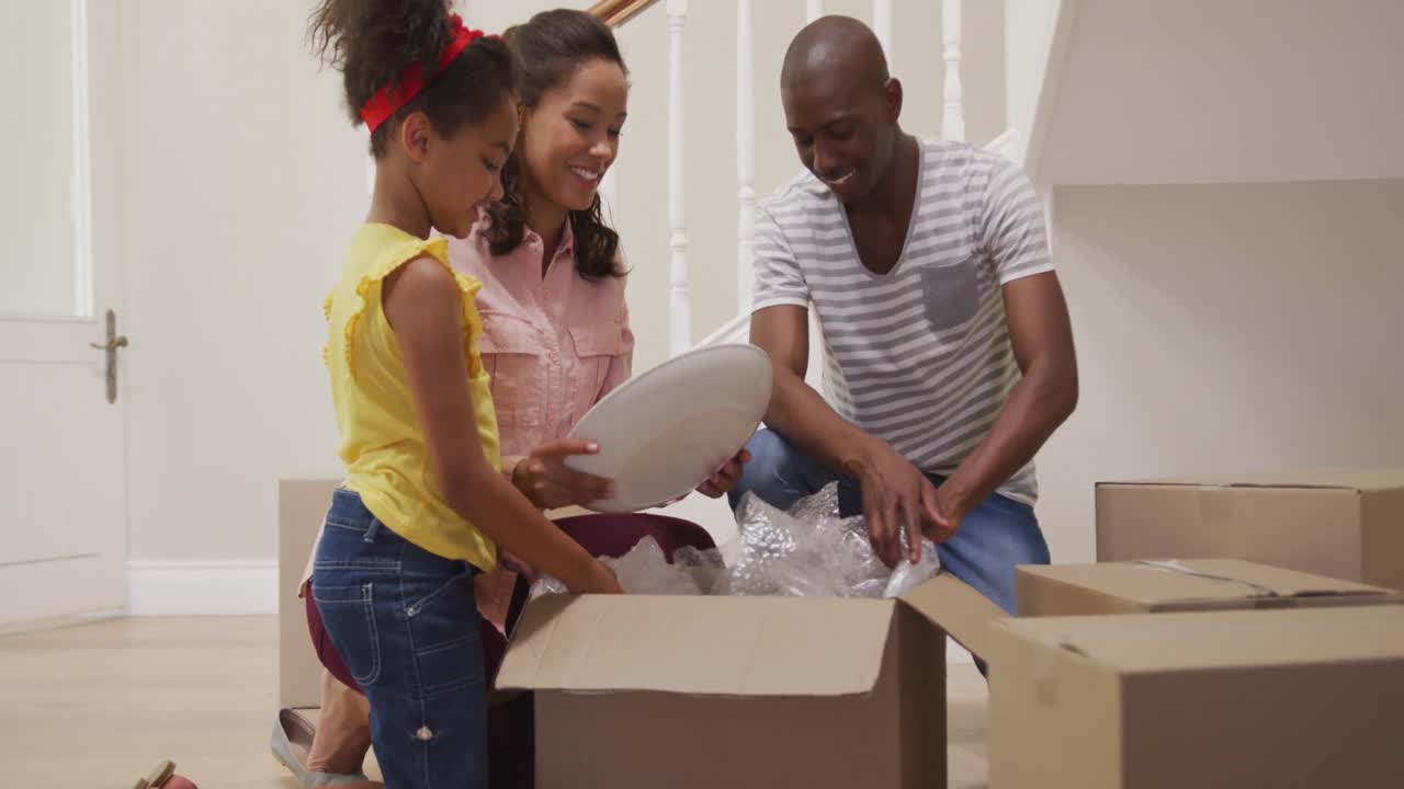 African American couple and their daughter moving into new house
