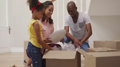 african american couple and their daughter moving into new house