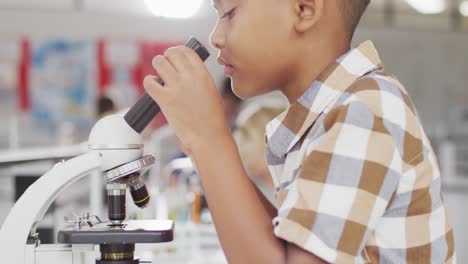 Video-of-happy-biracial-boy-with-microscope-during-lesson