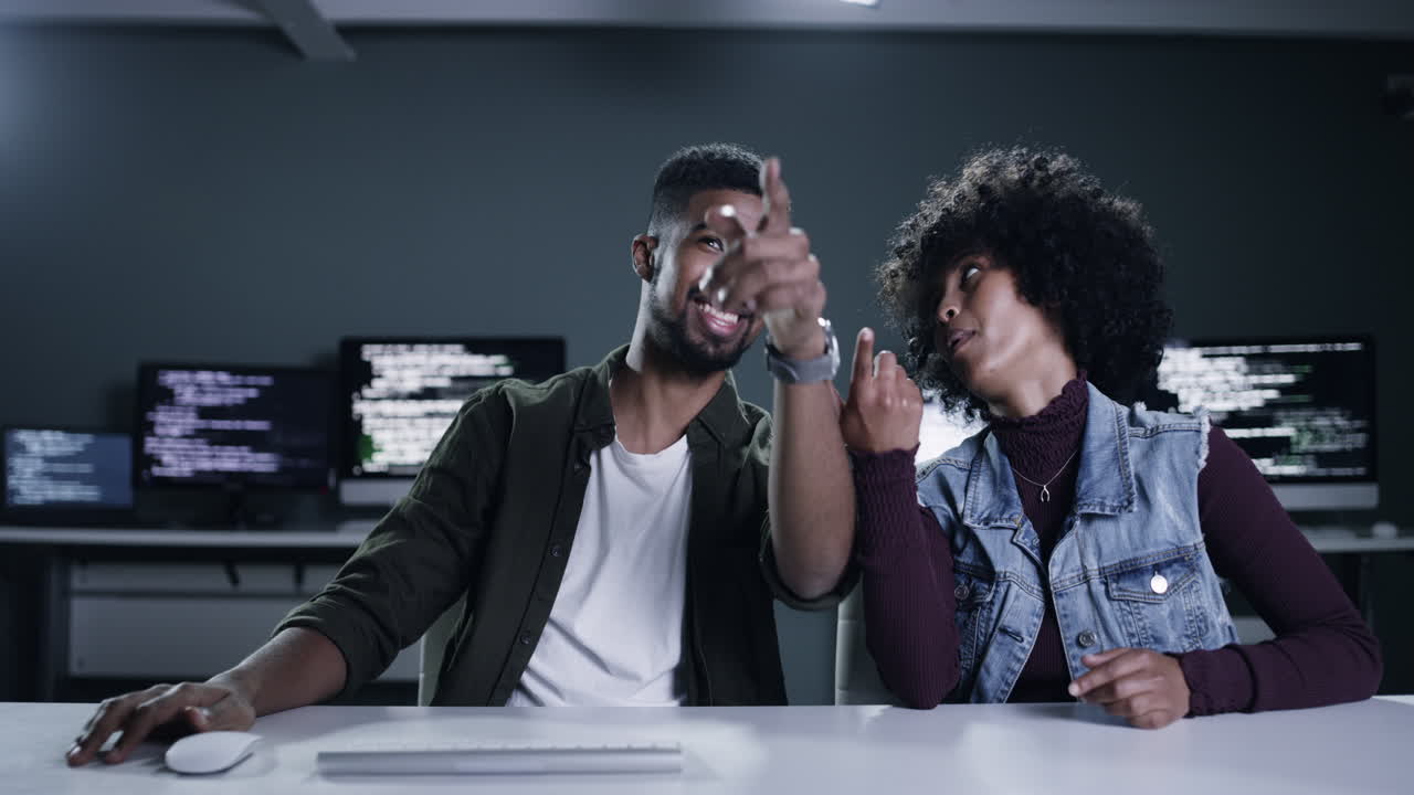 Two Colleagues Laughing Over Code