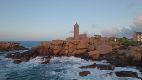 orbiting shot of phare du mean ruz lighthouse in bretagne france during sunset