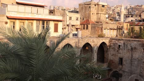 panning-shot-of-stone-middle-eastern-market-courtyard-with-palms-in-Tripoli,-Northern-Lebanon