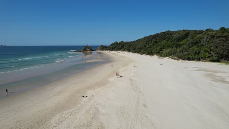 scenic landscape of clarkes beach with tourists in new south wales, australia - drone shot