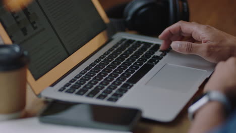 cerca de las manos de un empresario usando una computadora portátil en un café navegando por documentos enviando correos electrónicos empresario en línea en red disfrutando de la tecnología portátil