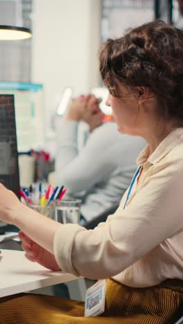 vertical video businesswoman participates at web chat event with a shareholder