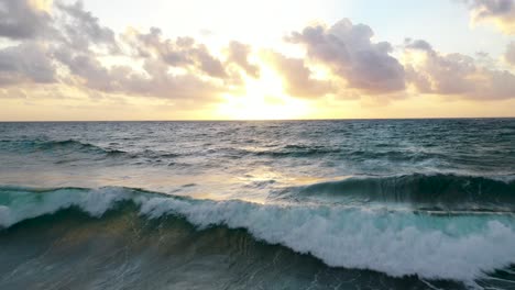 drone captures waves crashing at sunset on beautiful beach in tulum, mexico