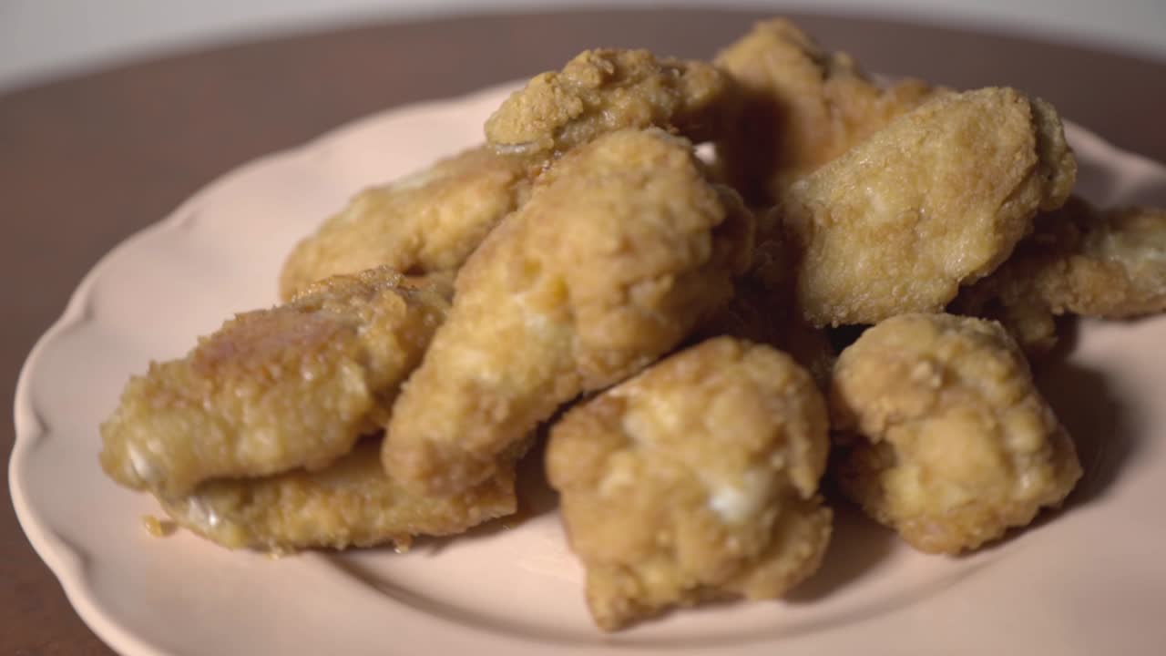 Crispy and Juicy Fried Chicken Wings on a Plate- Close up Shot