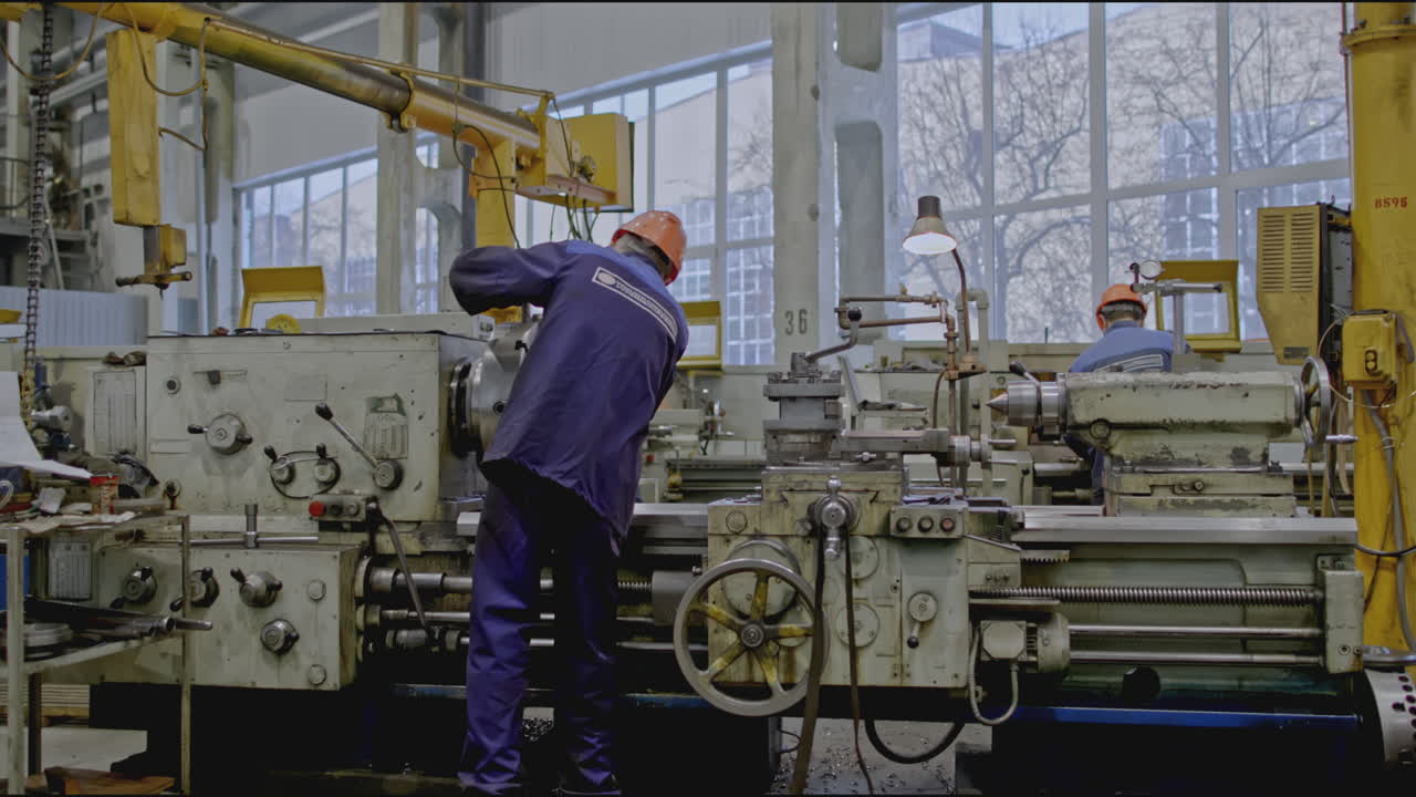 Factory Workers Operating Lathe Machines