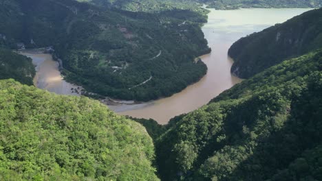 Serpentine-river-crossing-lush-forest,-Muchas-Aguas,-San-Cristobal-in-Dominican-Republic