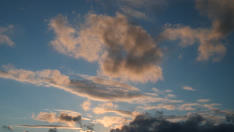 pink clouds moving fast in the evening sky