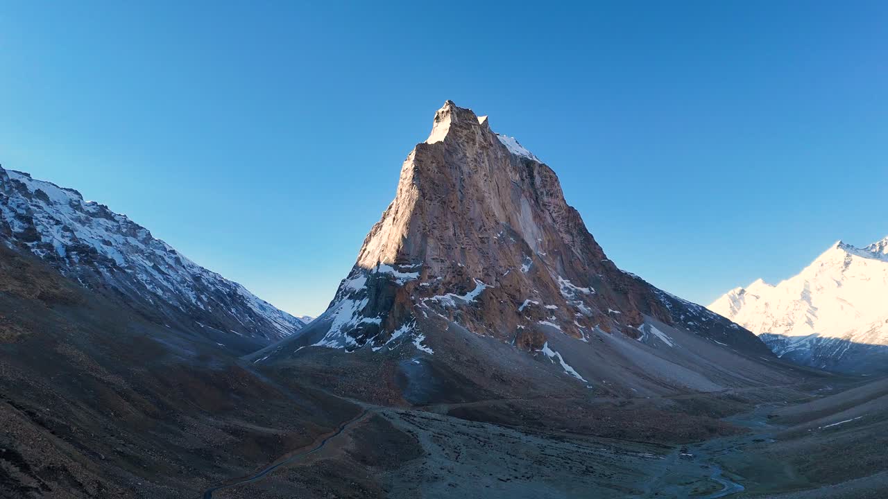 Aerial drone shot of Gumbok Rangan surrounded by soft morning light and golden hues.