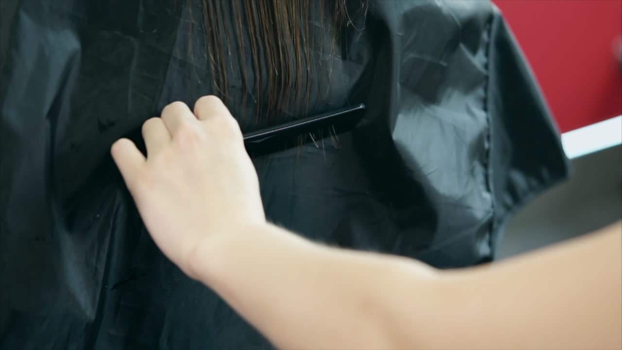 Woman getting a haircut at a salon