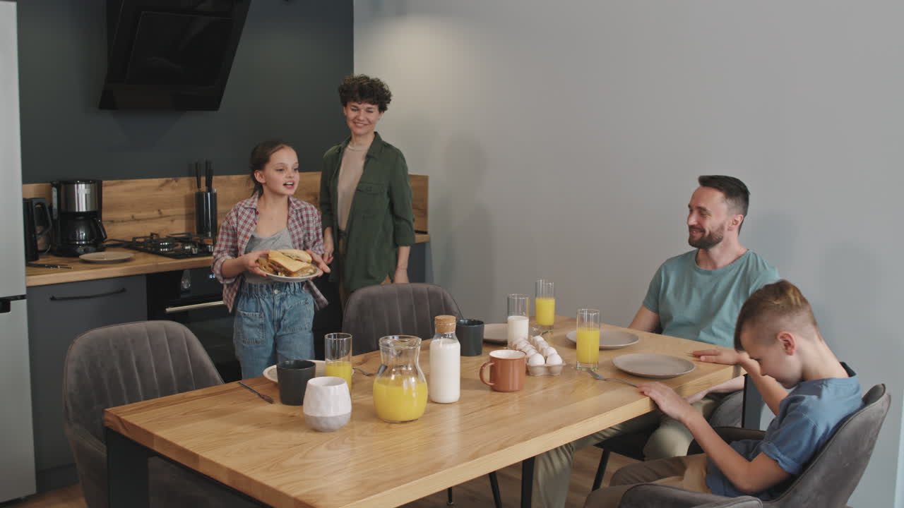 Happy Family Of Four Having Breakfast Together