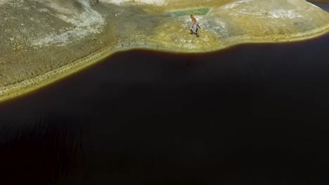 woman walking through a geological landscape