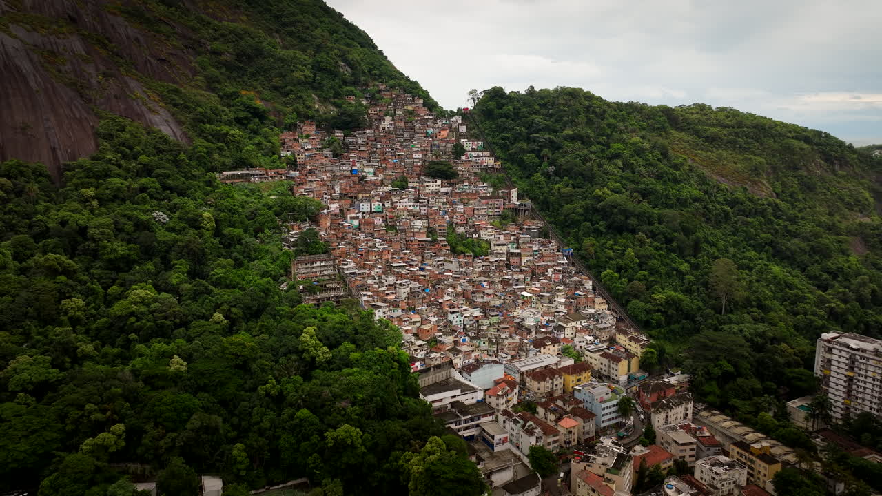 Favela in Rio de Janeiro on steep mountainside, aerial approach