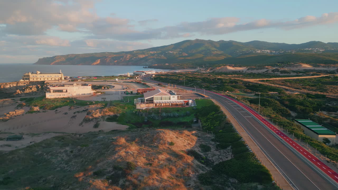 Aerial view sunset roadway and buildings. Sunset bathing coast in warm light.