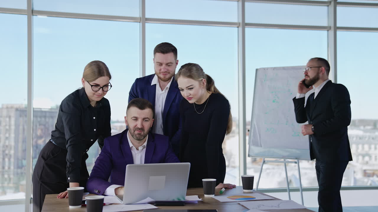 Businesspeople communicate and discuss issues on boss's laptop. Businessman speaking on the phone at the backdrop. Cityscape at the backdrop.