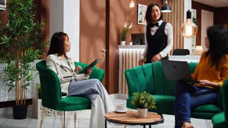 receptionist providing concierge services for guests in lobby