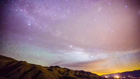 time lapse - milky way galaxy moving over the mountain range - 4k