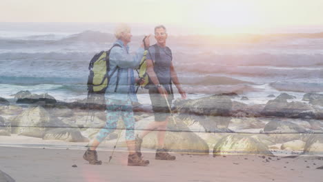 couple walking rocky beach during sunrise, with animated health chart and heart icon