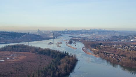 port mann bridge, fraser river, vancouver downtown background aerial