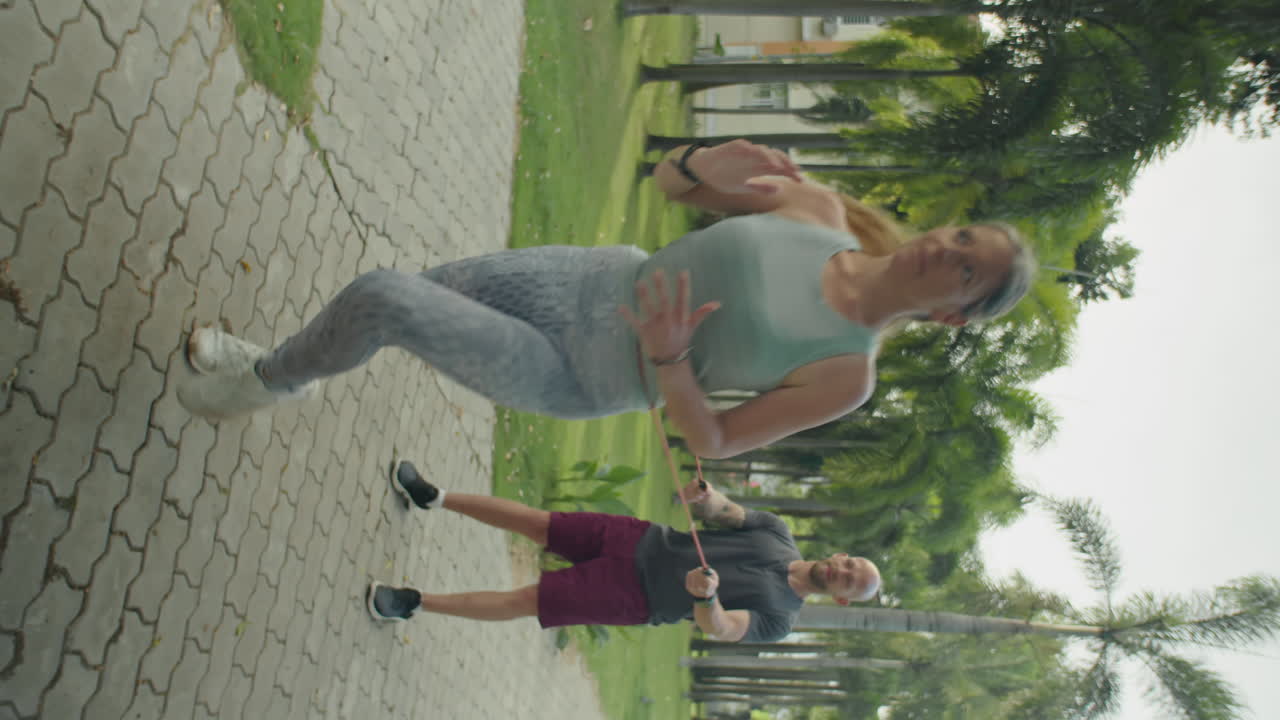 Woman Doing Resistance Band Exercise with Personal Trainer