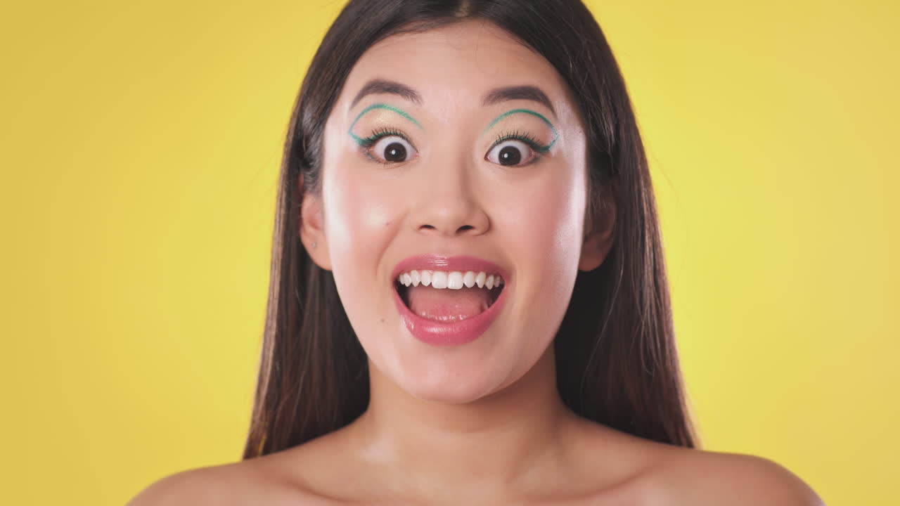 Woman with vibrant makeup and a joyful expression
