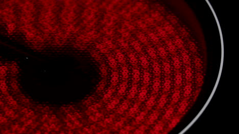 A close-up shot of an electric hob or stove heating up and turning red
