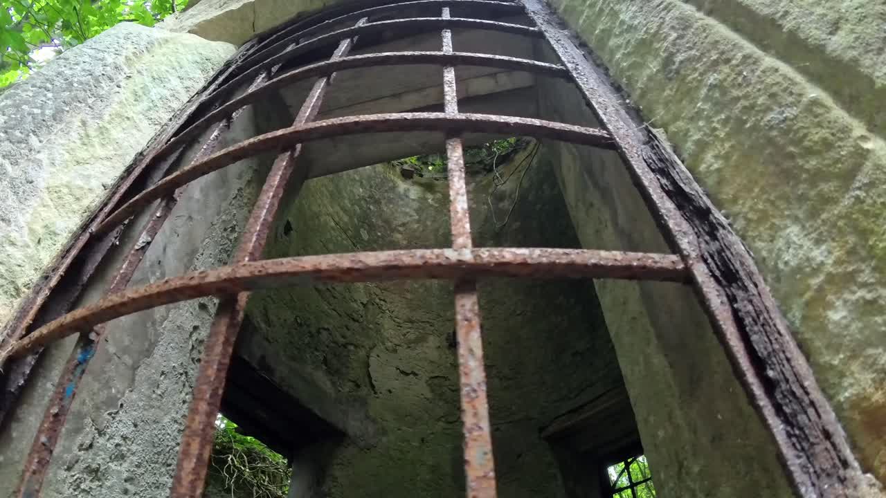 Old medieval stone castle rusted iron bars covering open window for security
