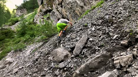 Cute-young-boy-having-struggle-climbing-mountain-full-of-rubble