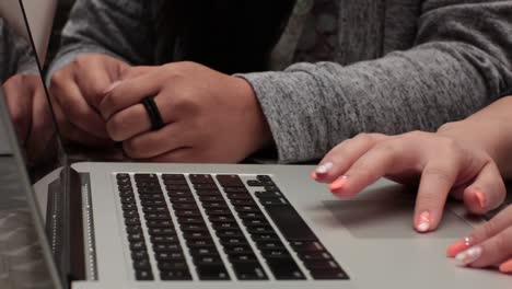 Close up of a student typing on her laptop.