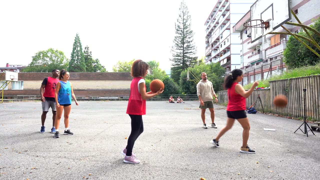 People playing basketball outdoors