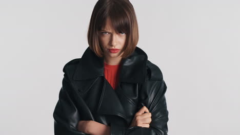 upset woman crossing arms in leather jacket