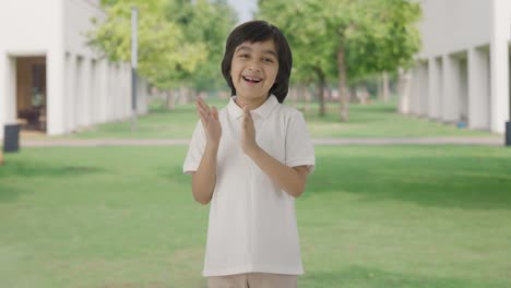 Happy-Indian-boy-clapping-and-appreciating-in-park