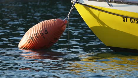 beautiful yellow fishing boat moored in coastal harbour, closeup