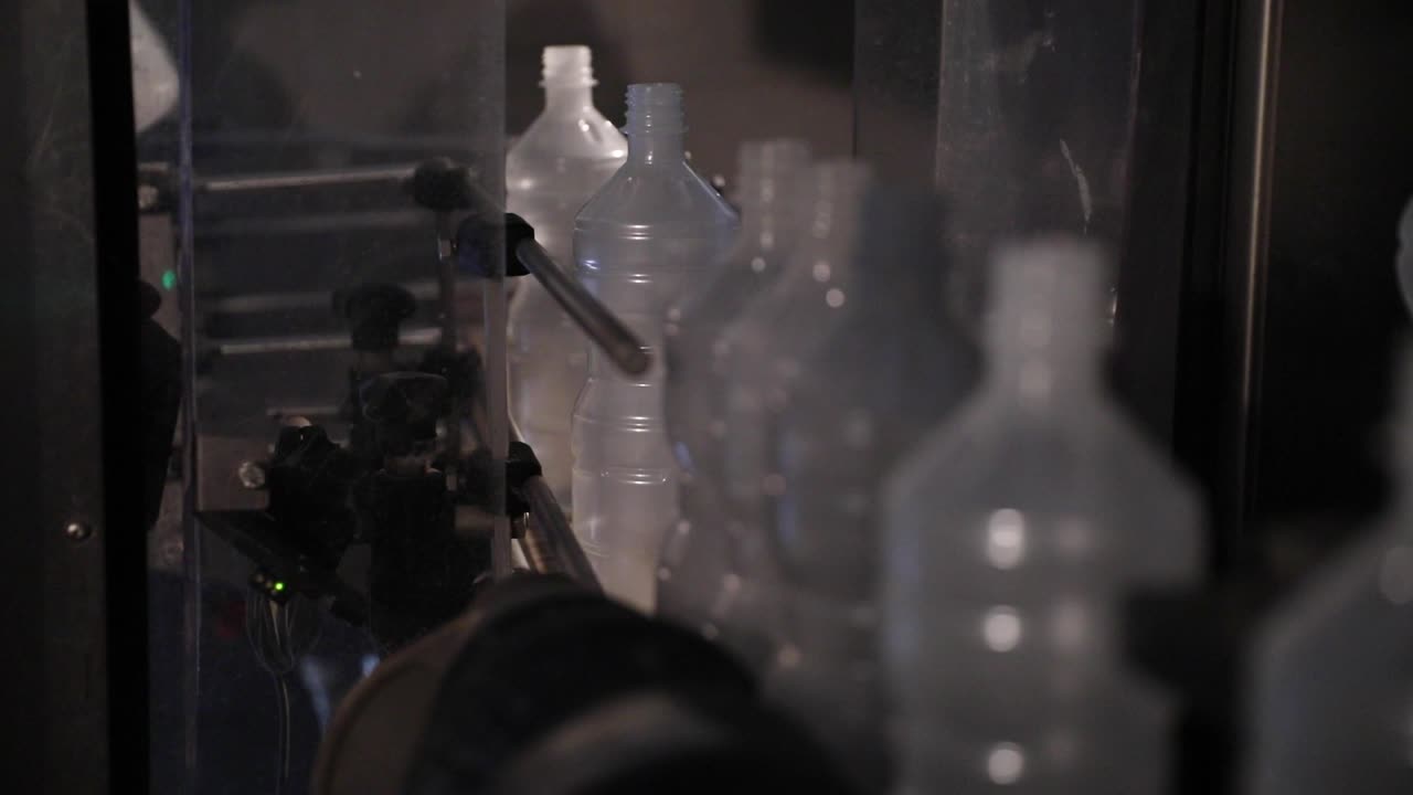 Empty Plastic Bottles Being Loaded onto Conveyor Belt Vinegar Factory