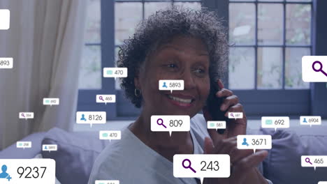 Animation-Von-Social-Media-Metriken-über-Einer-Frau,-Die-Am-Telefon-Spricht-Und-Lächelt
