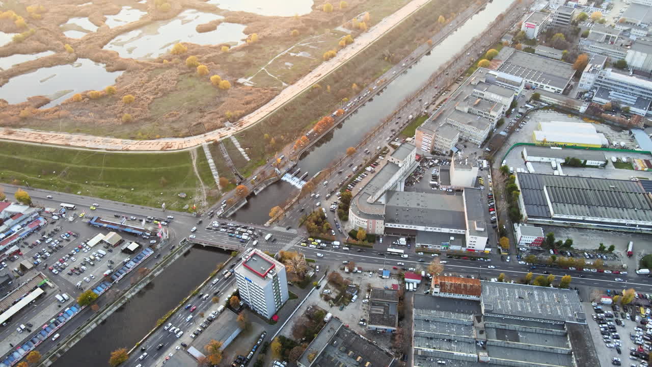 Streetscape of Bucharest, lakes in a park and crossroads near the water channel with lots of moving cars. View from the drone, Romania
