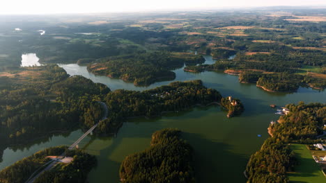 aerial overview of stausee ottenstein reservoir as sunlight reflects across winding water tendrils