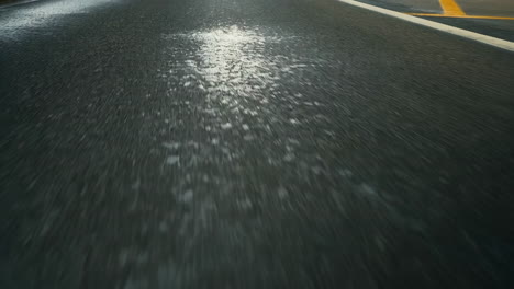 wet road surface with light reflections and motion blur