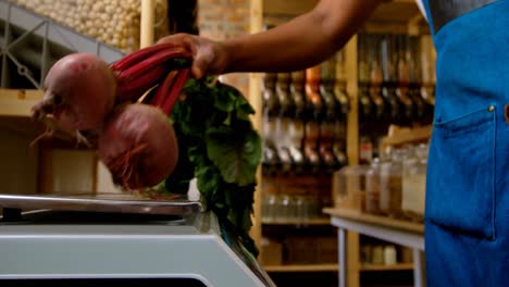 male staff weighing beets on weighing machine 4k