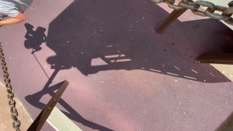 overhead shot of a child swinging on a swing