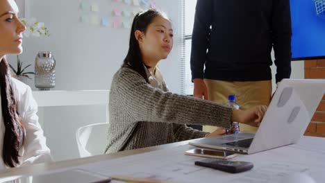 business colleagues discussing over laptop in conference room 4k