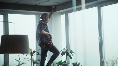 technician installing a security camera in an office