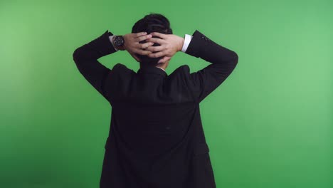 businessman with hands on head - back view